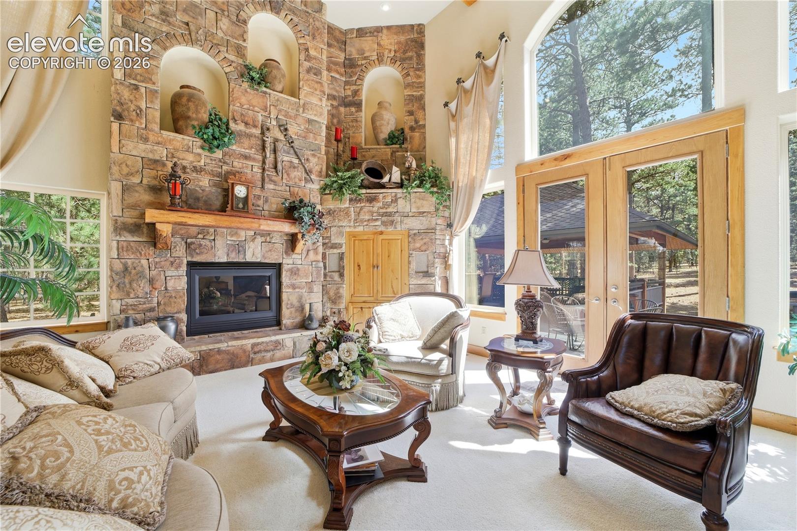 Great Room has stone fireplace, rustic wood mantle, 3 decorative coves