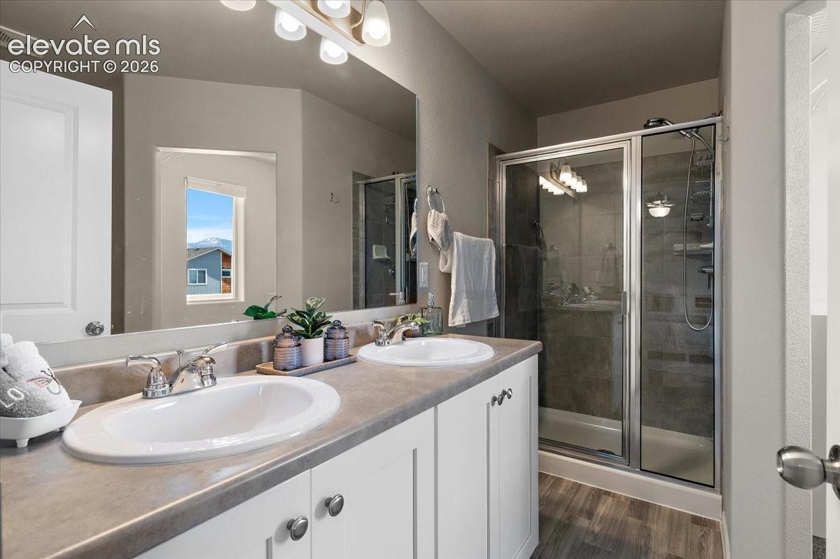 Dual vanity with undermount sinks, chrome fixtures, and white cabinetry