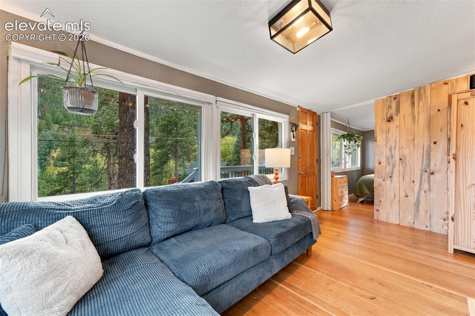 Large windows with vertical wood plank wall paneling.