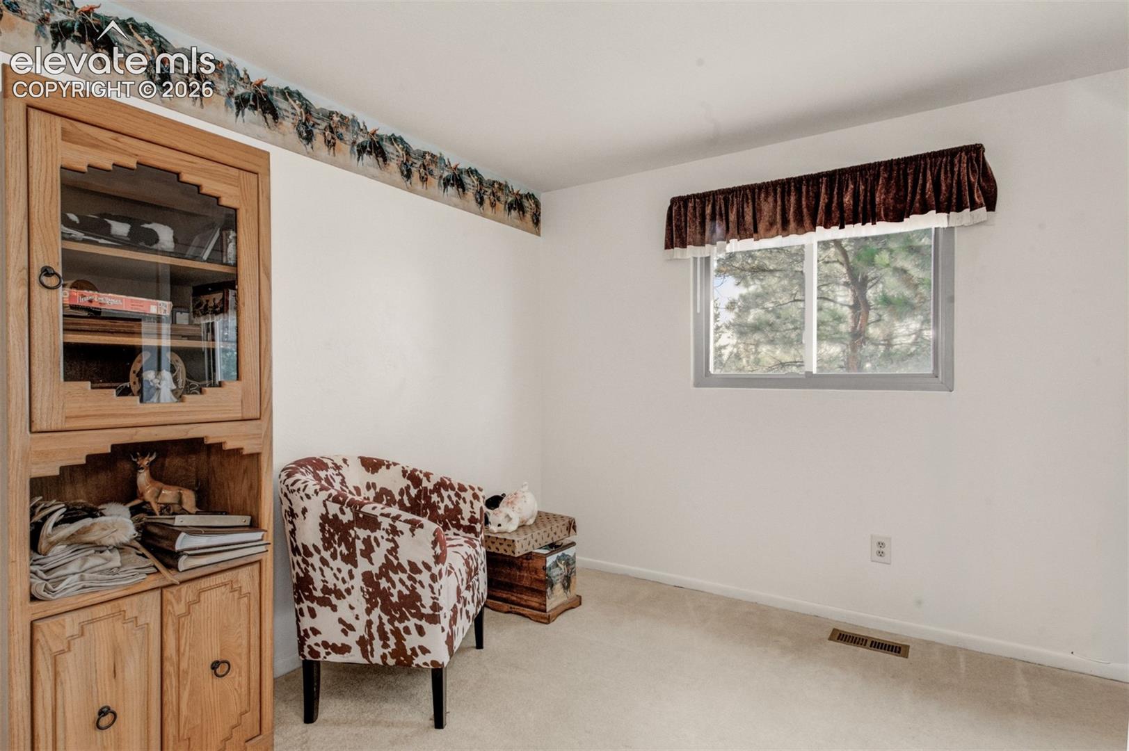  Bedroom three with wall-mounted valance over window, and wall-to-wall carpeting