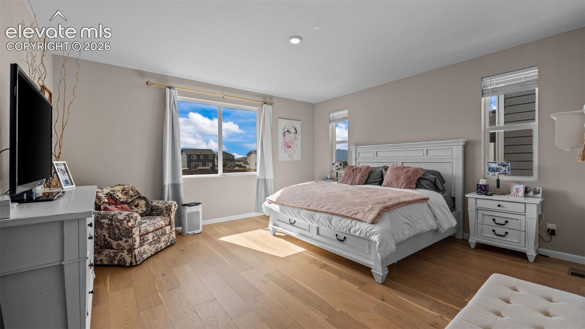Recessed lighting, wood-finish flooring, and multiple windows
