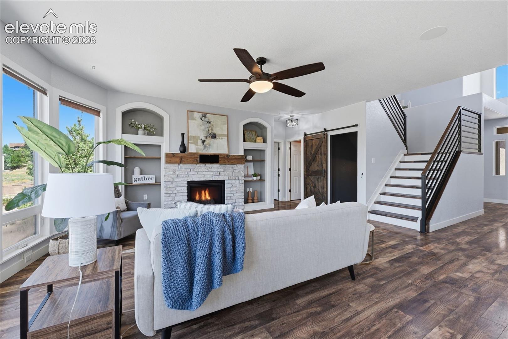 Stone fireplace, barn doors, horizontal rails and painted stair risers!
