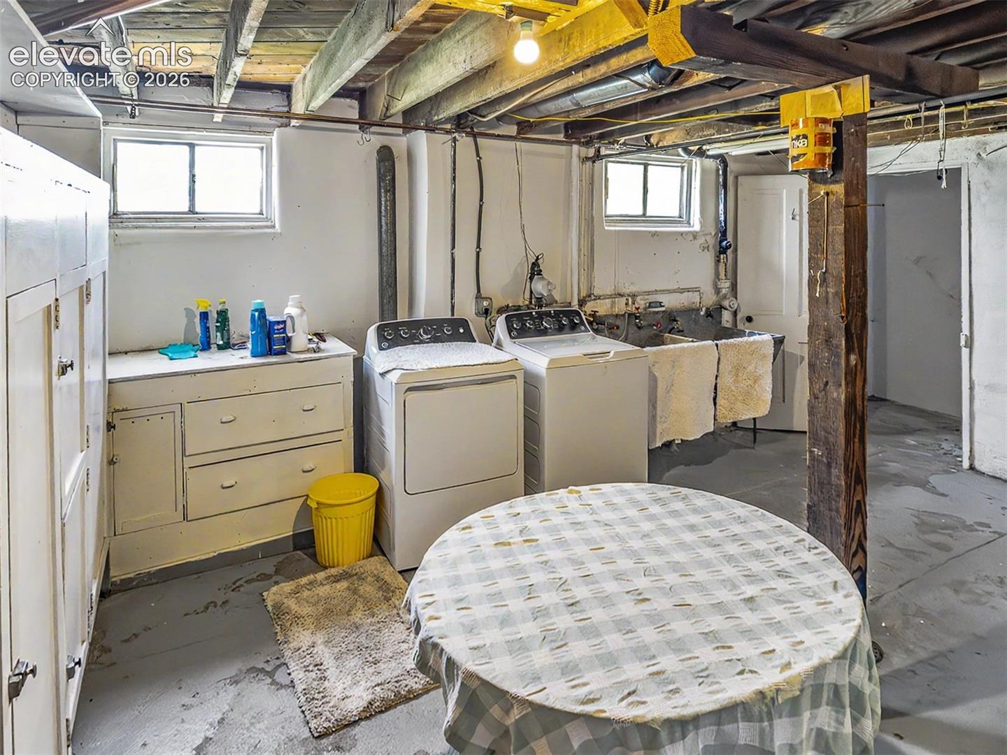 Huge laundry area WITH laundry shoot from above and concrete