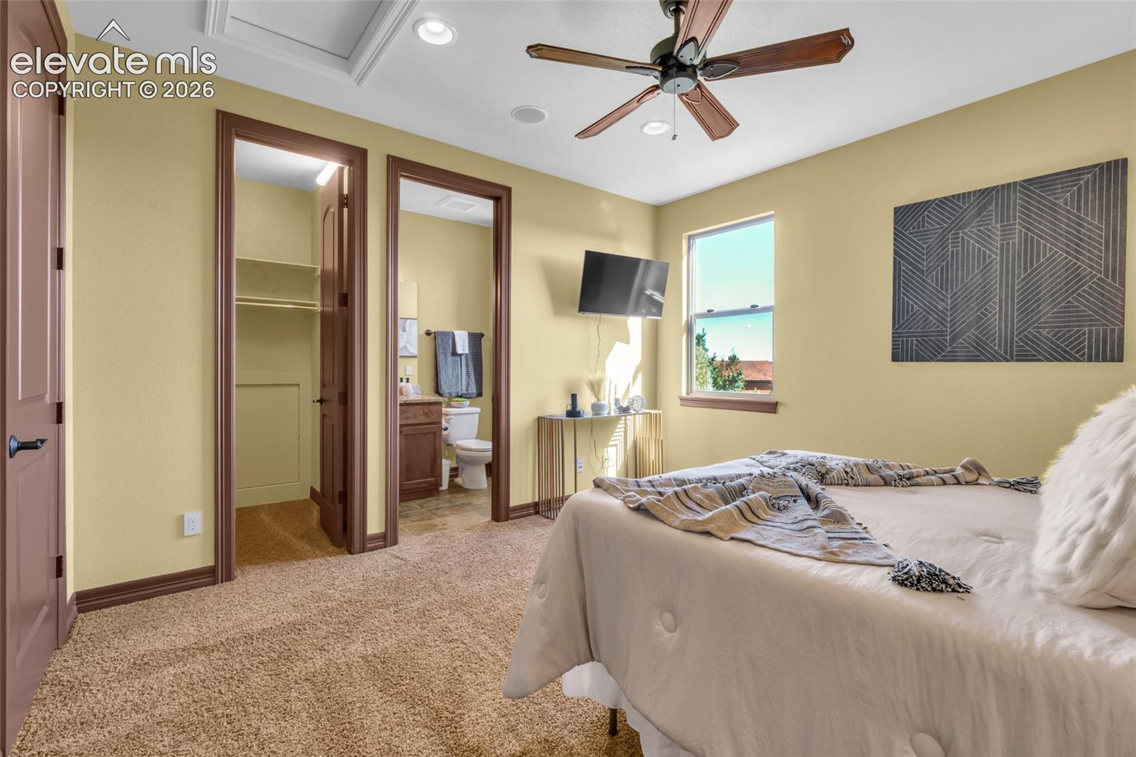 Bedroom featuring carpeted flooring, a ceiling fan with integrated lighting, recessed lighting, and a window providing natural illumination
