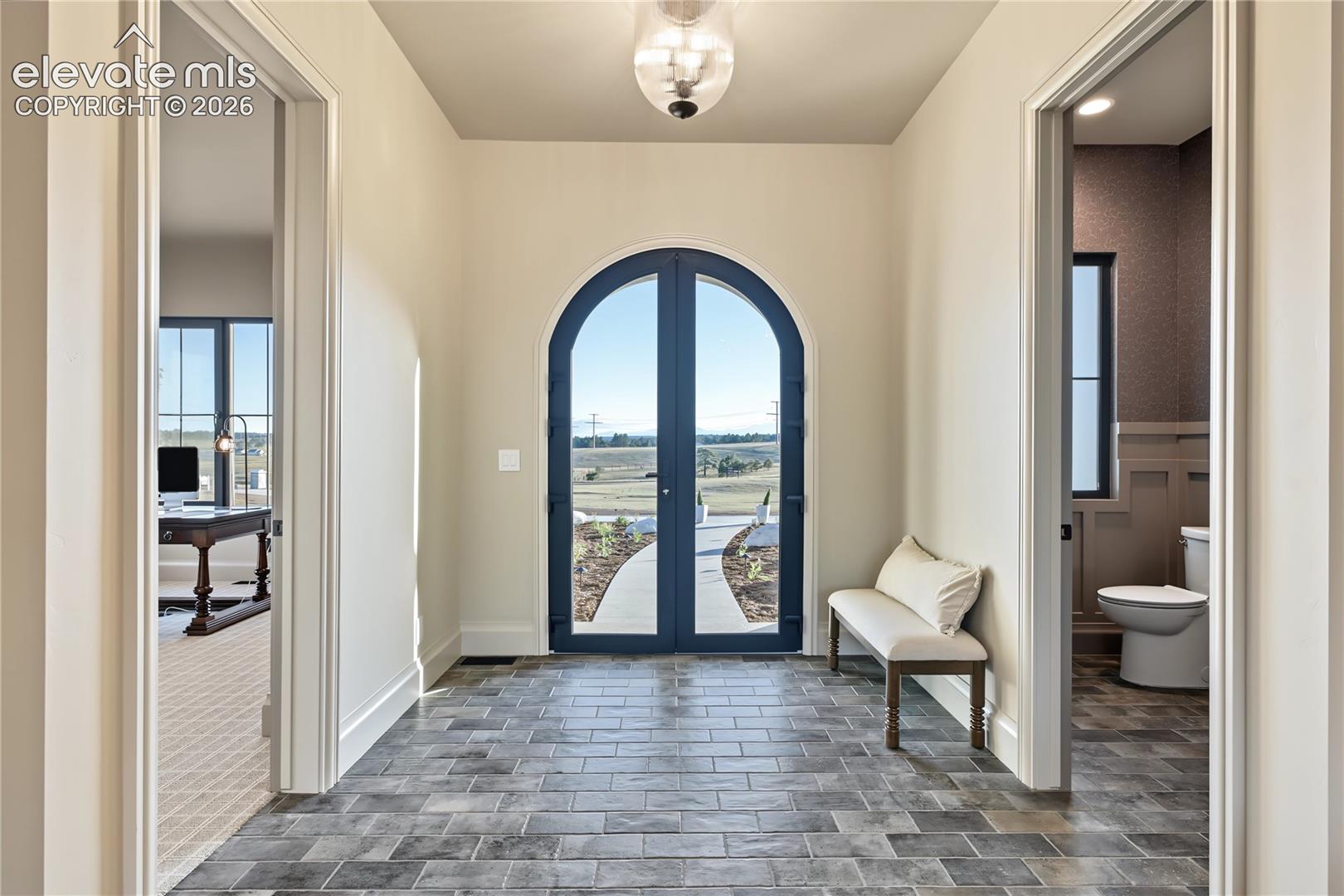 Elegant entry with arched double doors