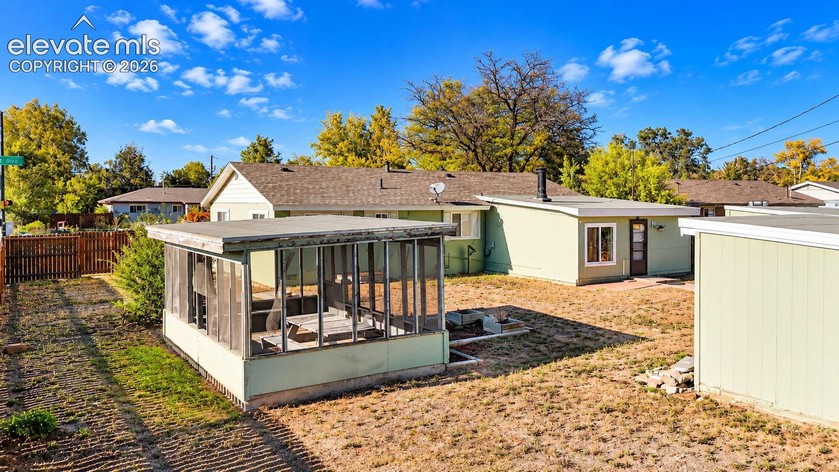 Spacious, fenced backyard featuring a rear addition, and open outdoor space with opportunities for gardening and recreation.