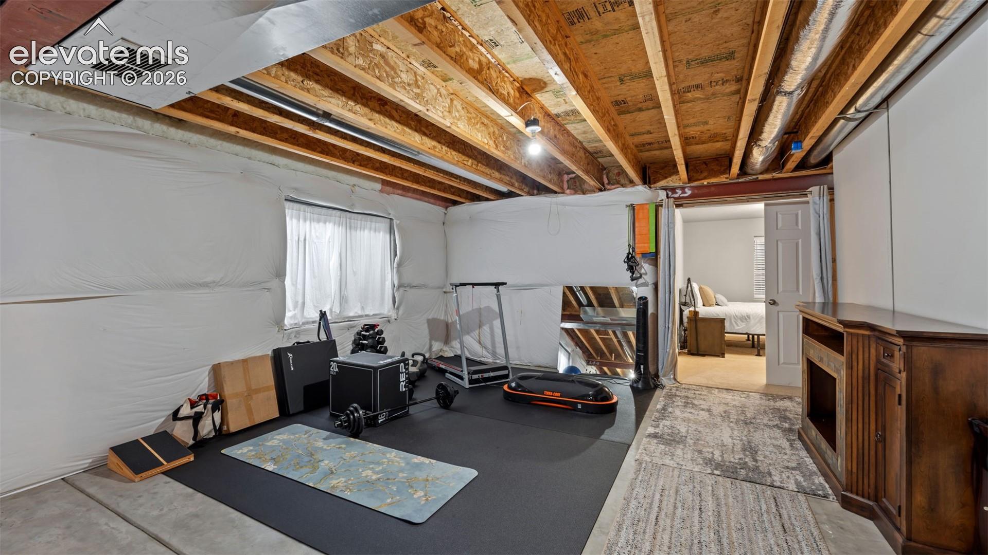 Lower level space featuring exposed joist ceilings, concrete flooring, and insulated foundation walls