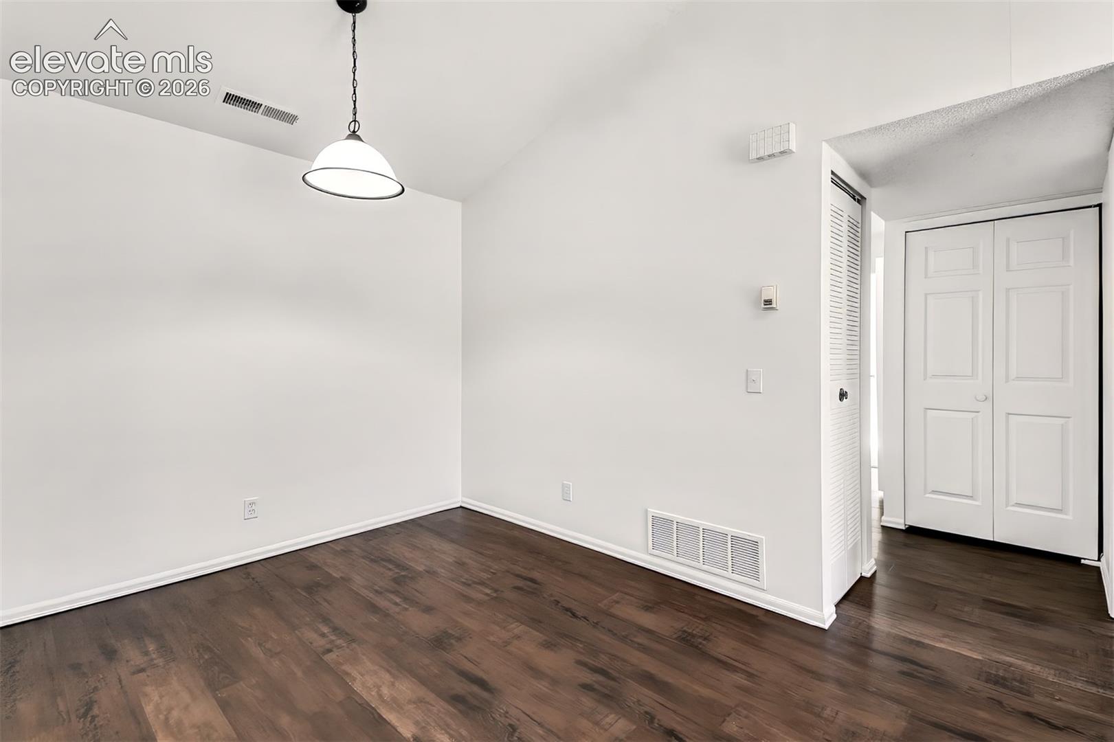 Dining area with updated lighting and luxury vinyl plank flooring.