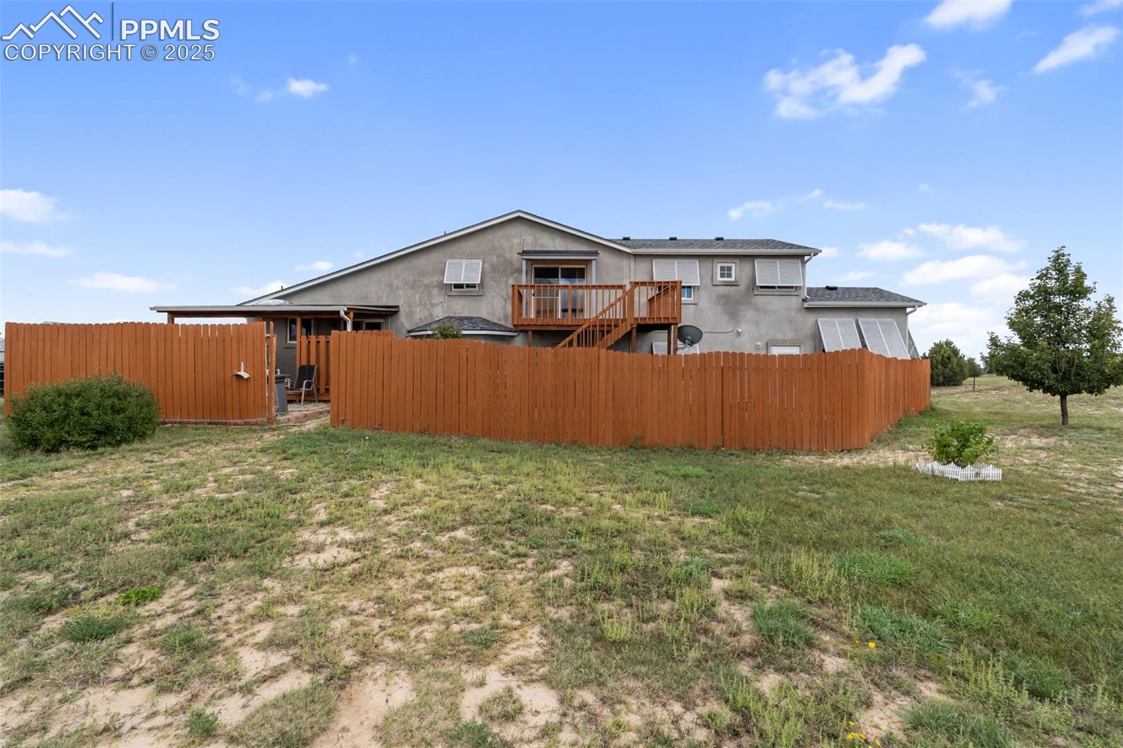 Rear exterior with deck and fencing