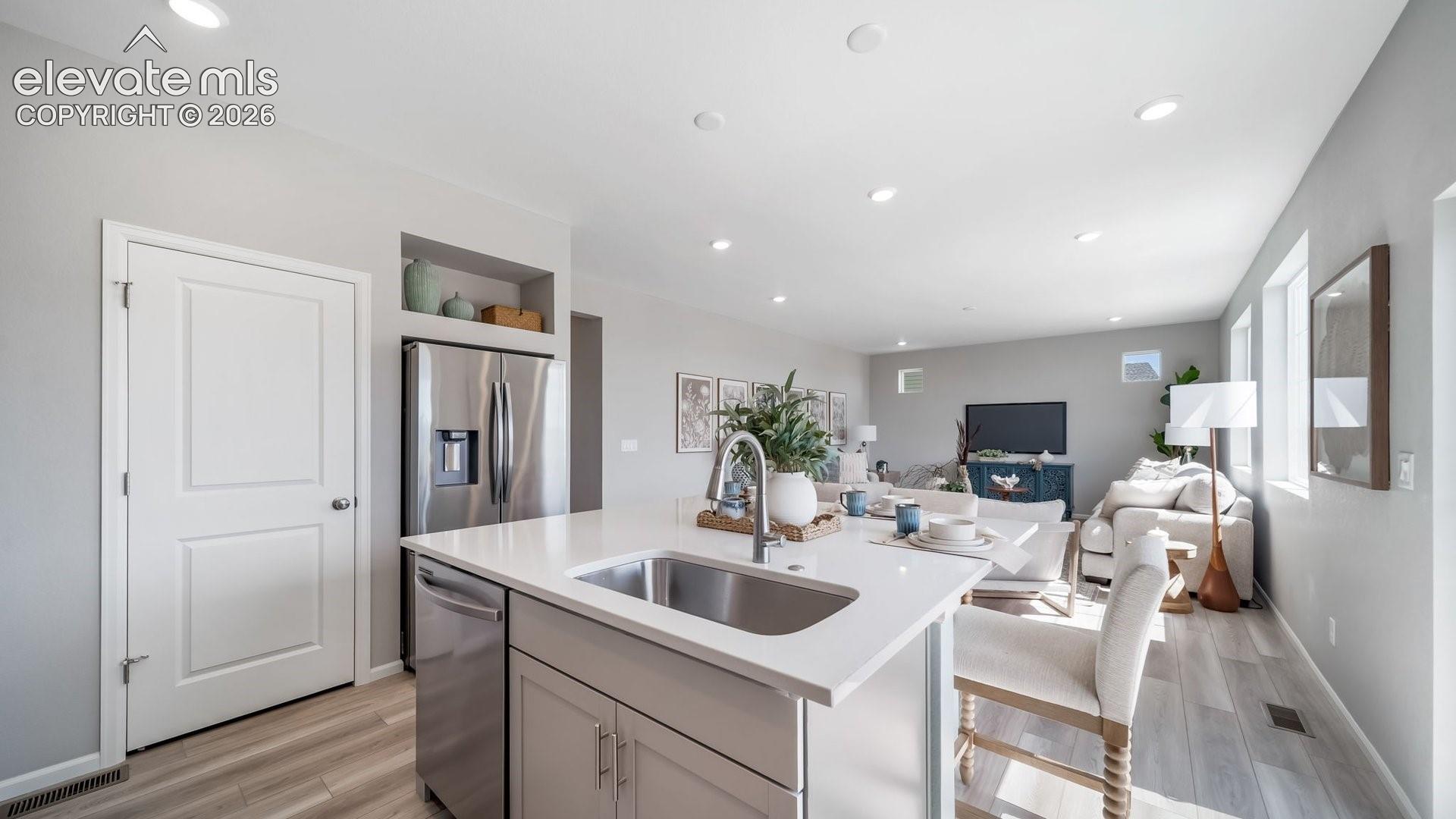 Kitchen island with an undermount sink and a matte black faucet
Photos of a model home