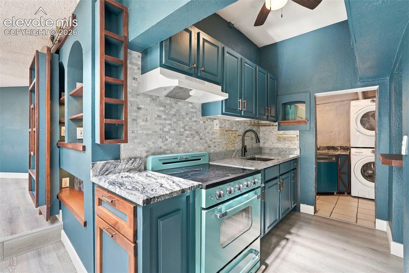 Classic Retro Brand Stove, stone countertops, Built-ins and overhead storage, mosaic tile backsplash, and ceiling fan