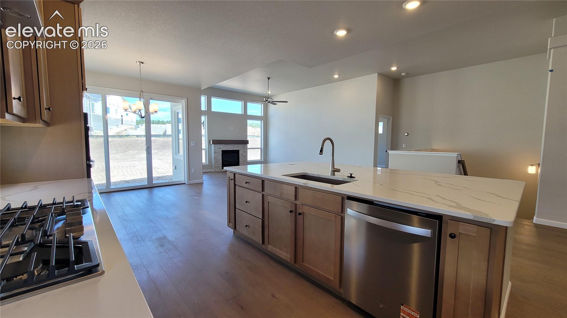 Gourmet Kitchen with quartz countertops, pantry, huge island providing additional seating, stainless steel gas cooktop, combo built-in microwave and oven, pyramid hood, and dishwasher! 