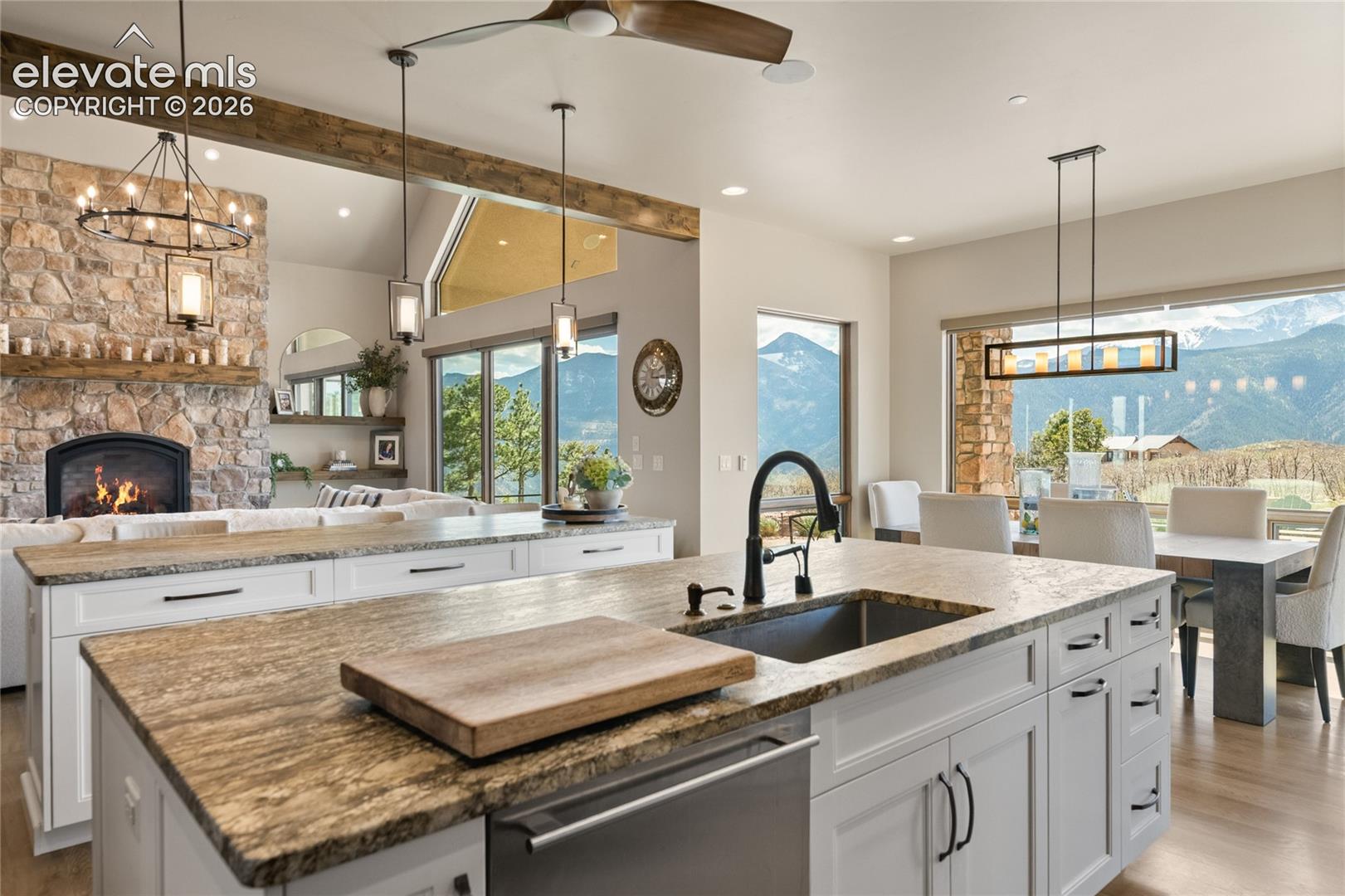 Oversized leathered granite prep island with deep undermount sink, opening to the great room and dining area for seamless entertaining.
