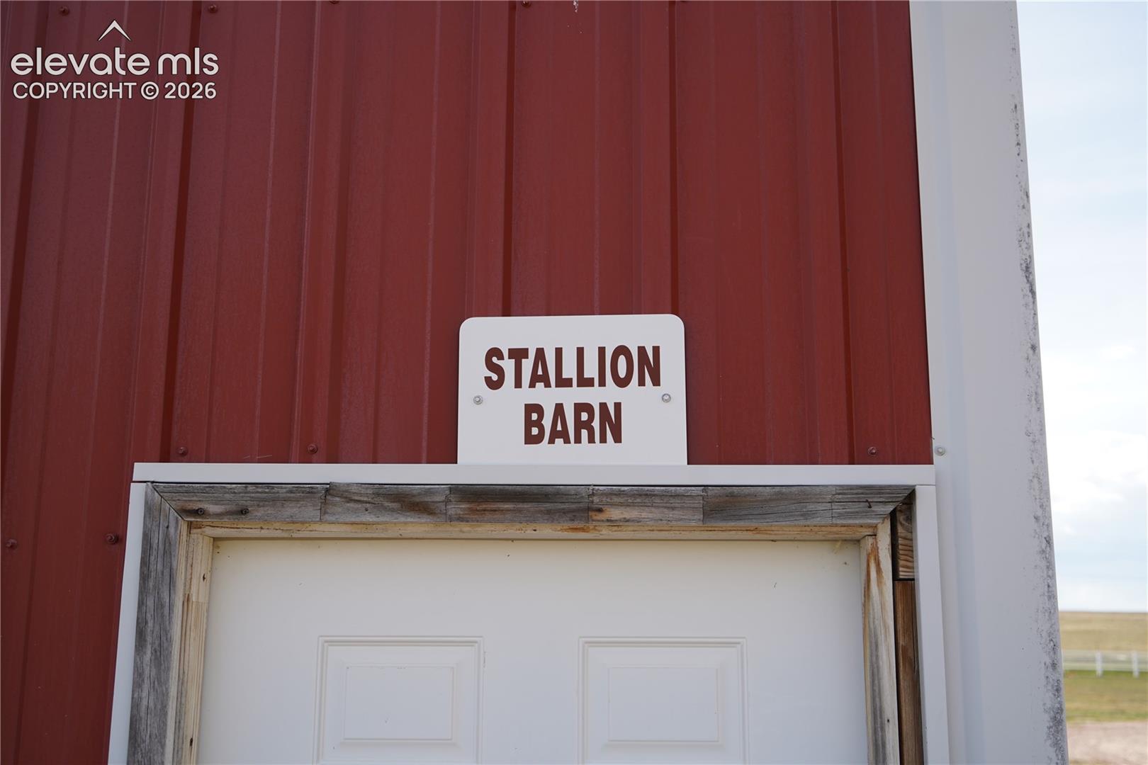 Red corrugated metal siding with white trim