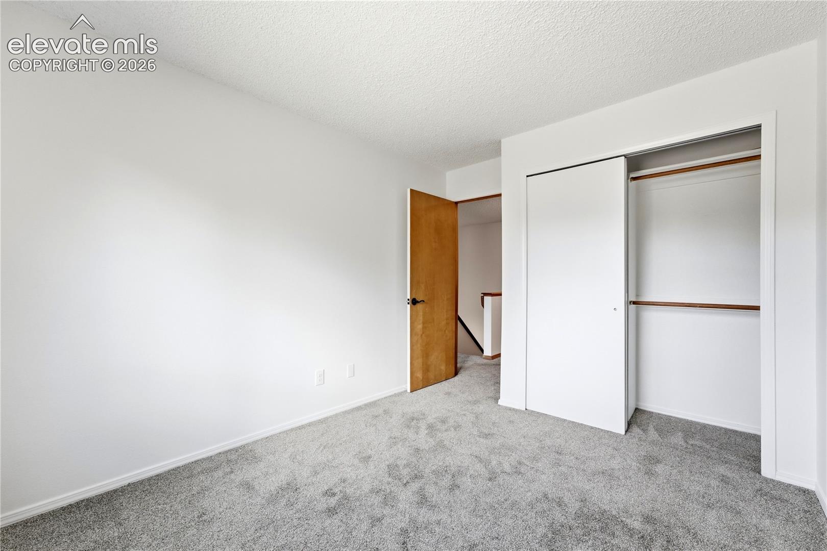 Light gray carpet, white walls