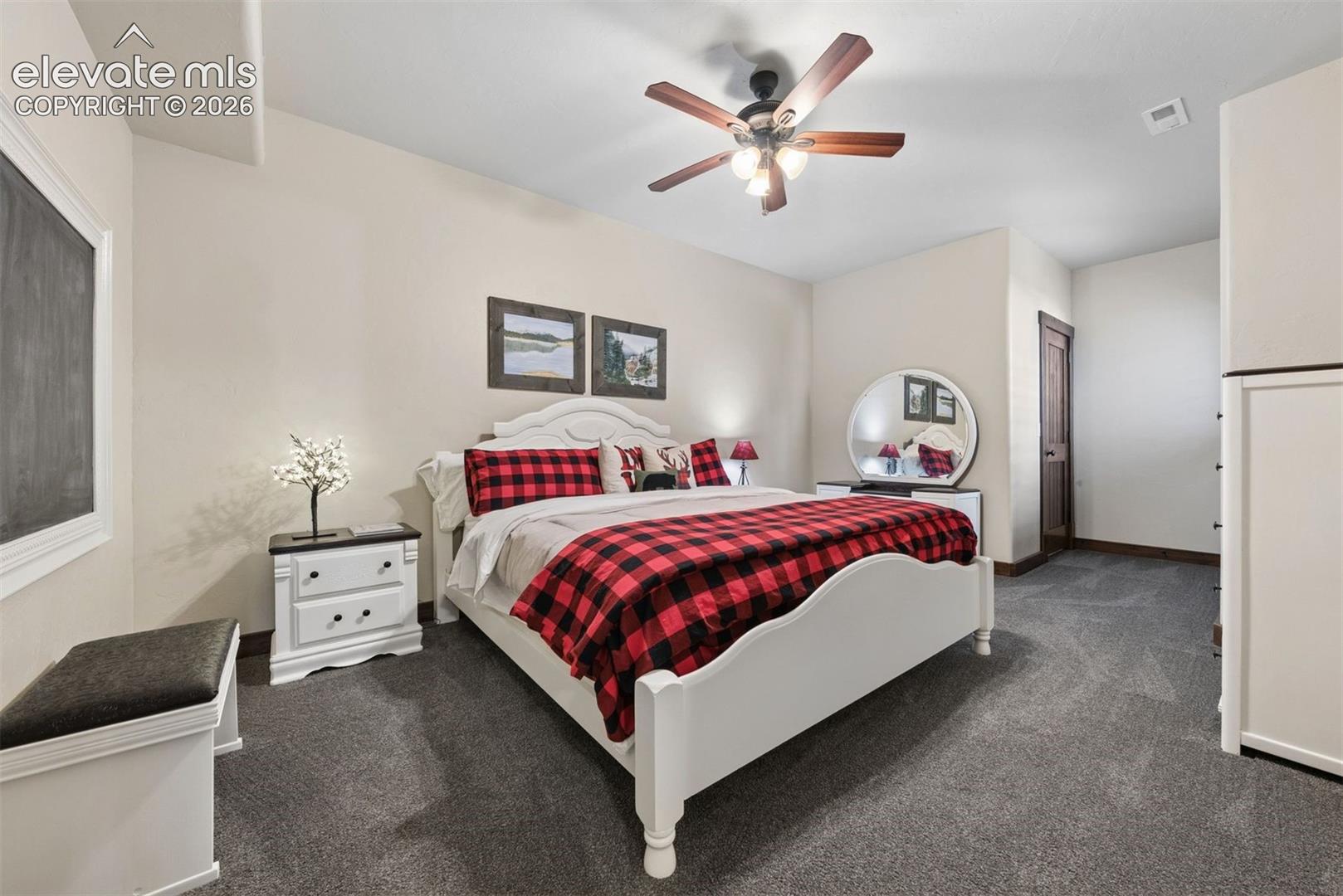 Spacious room featuring plush wall-to-wall carpeting, a multi-blade ceiling fan with integrated lighting, and a neutral color palette