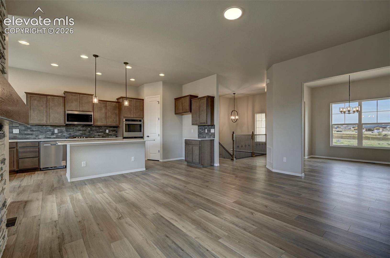 great room open to kitchen and dining
