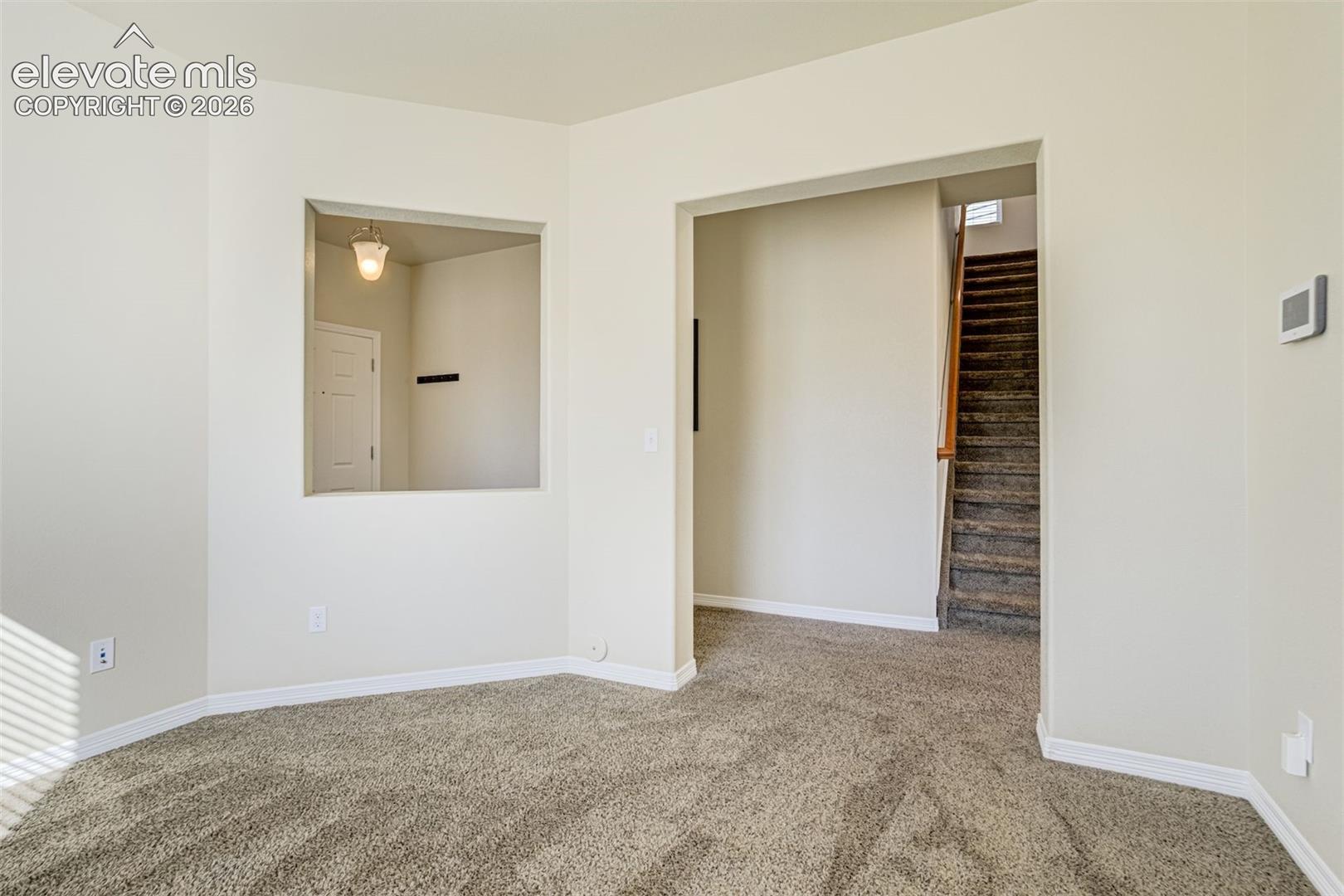 Plush carpeting, neutral wall colors, and an open archway