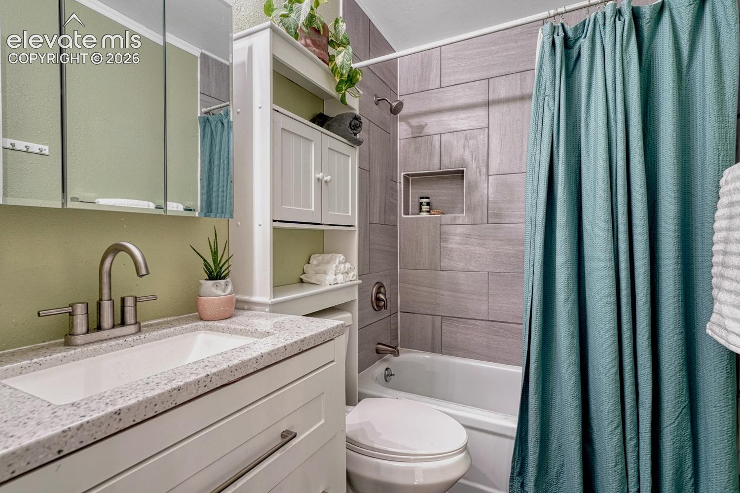 The Upper Level Full Bathroom offers a vanity, mirrored medicine cabinet, over the toilet cabinet, and tiled tub/shower.