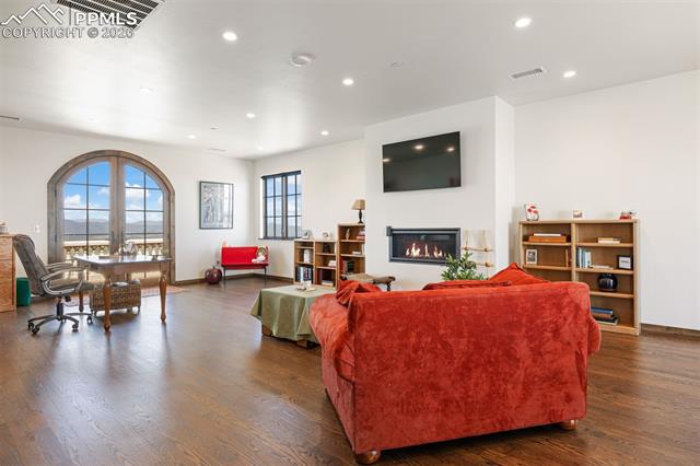 Crow's nest flex space with fireplace, bathroom, arched balcony door, and mountain views, ideal for a lounge, office, or studio.