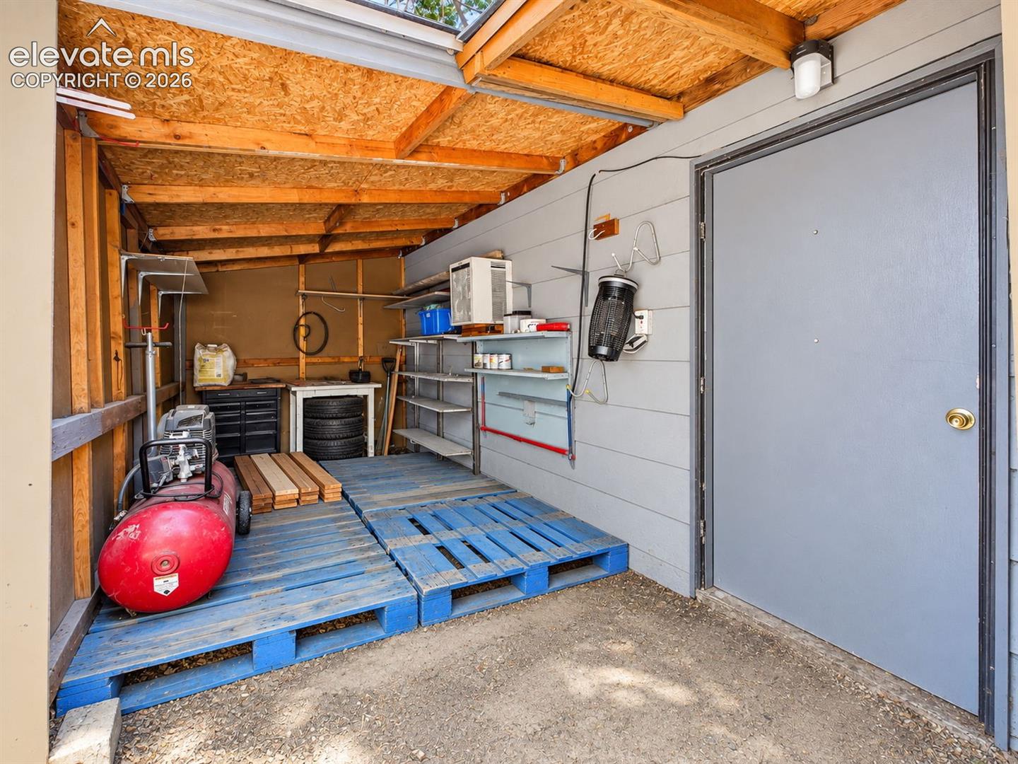 Additional covered storage space offers shelving and room for tools, supplies, and project equipment.