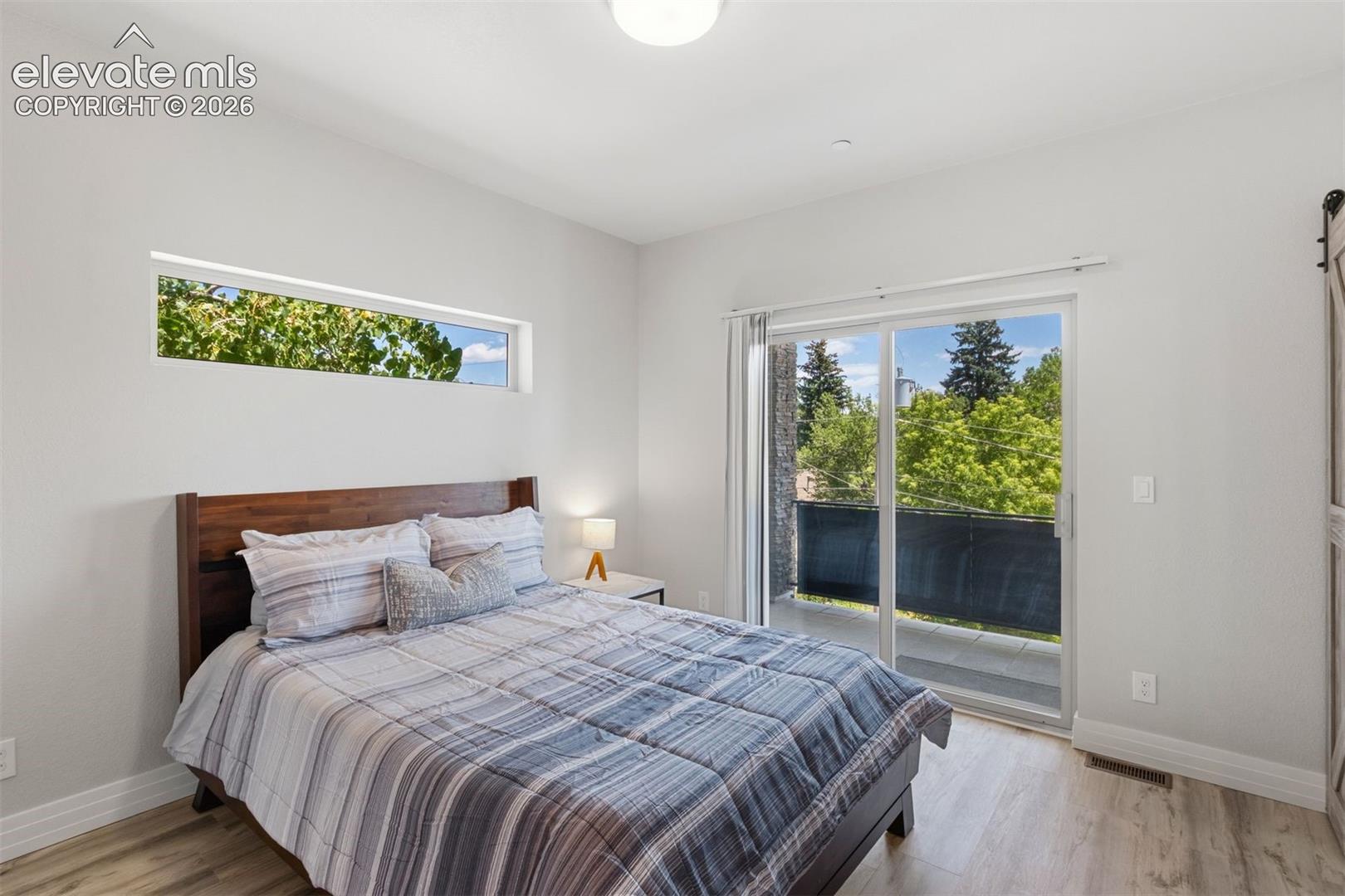 Primary bedroom with ensuite bath, walk in closet, and private deck access to roof top