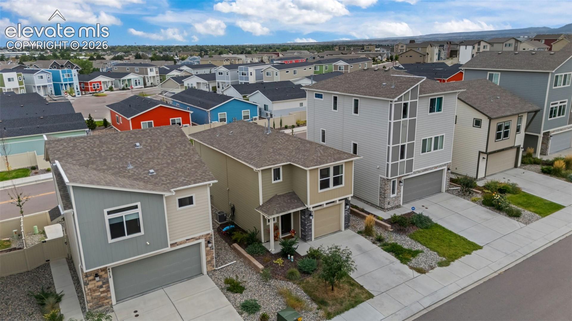 Contemporary architecture featuring multi-story designs, attached garages, and paved driveways