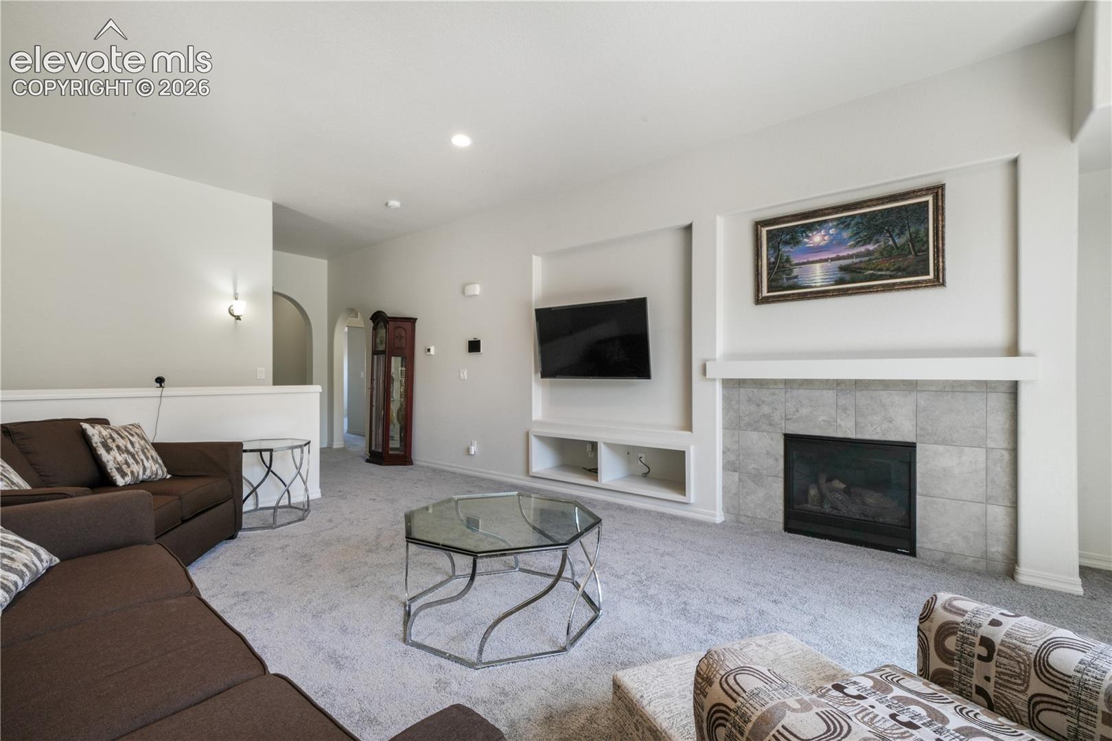 Livingroom with open concept, gas fireplace, large patio sliding doors and new carpet