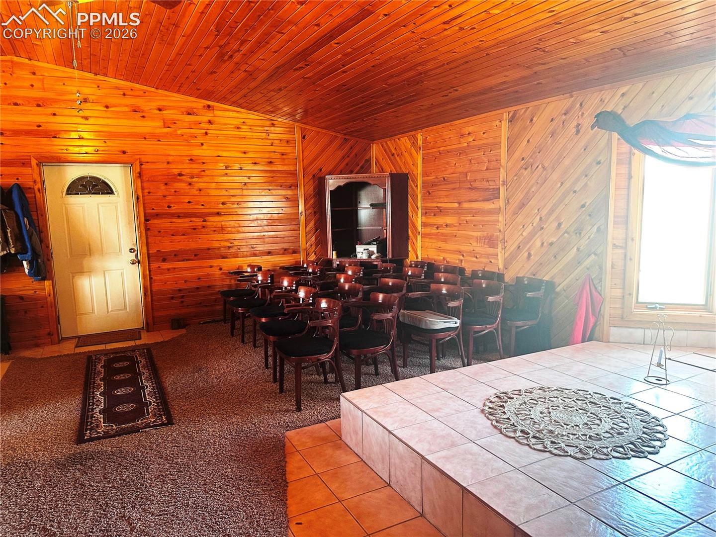 Massive multi-purpose room for; meeting, music, church sanctuary, yoga, or whatever with seating for 40 or so people.  Elevated stage.