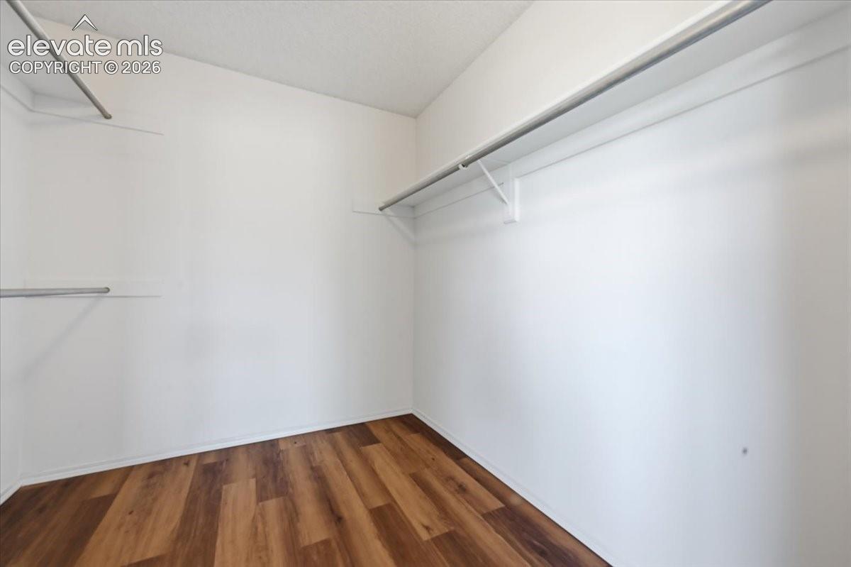 Large primary suite walk-in closet with built-in shelving at , Colorado Springs, CO.