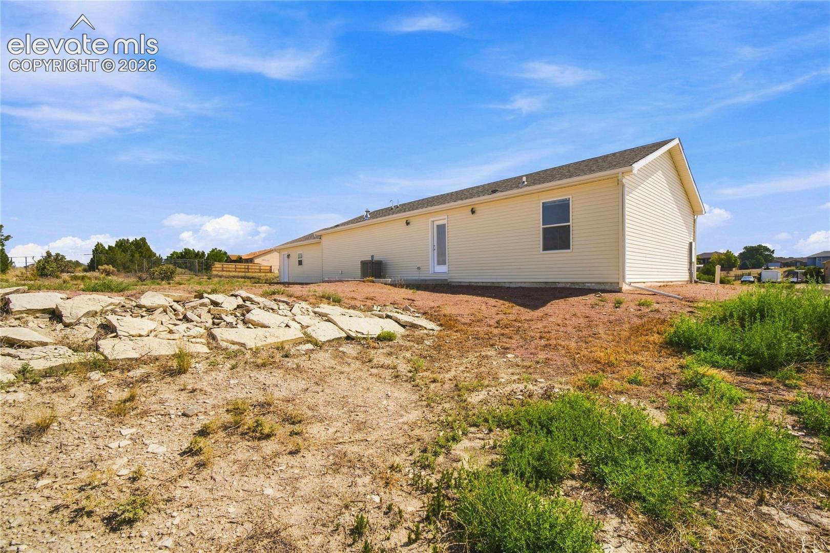 Spacious manufactured home situated on expansive rural grounds with clear sightlines across the property