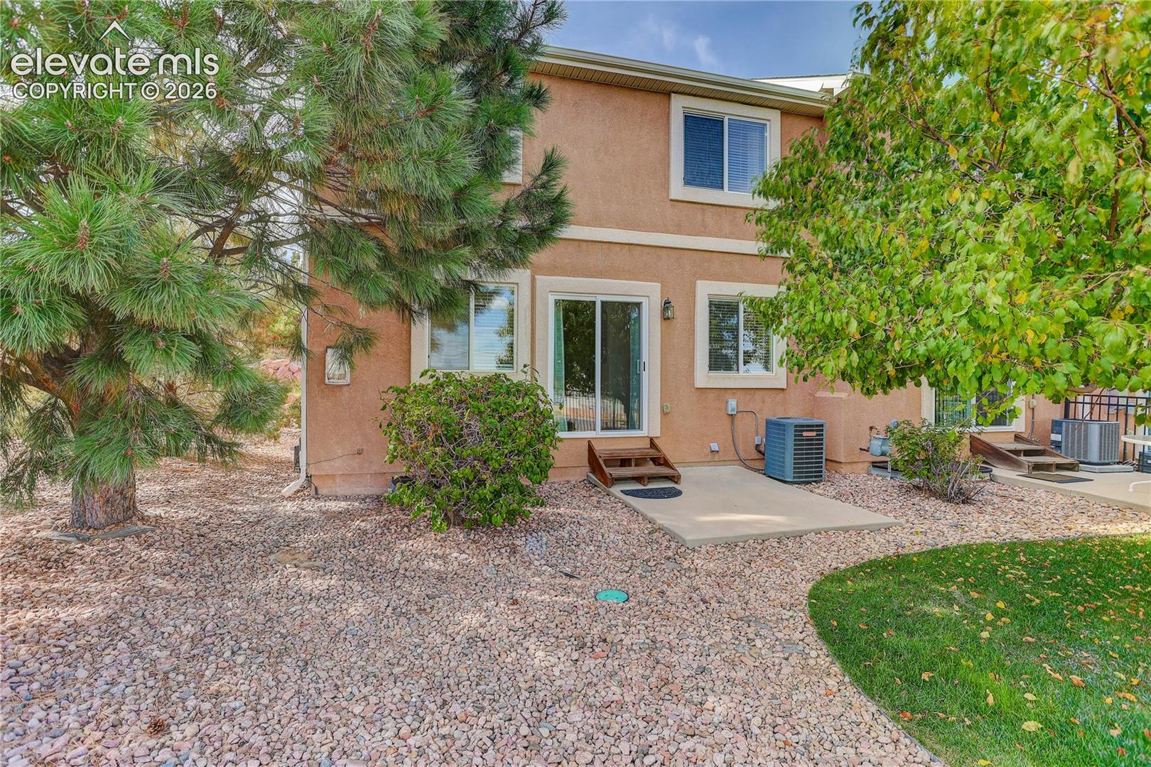 Back patio and back yard enclosed in community fence.