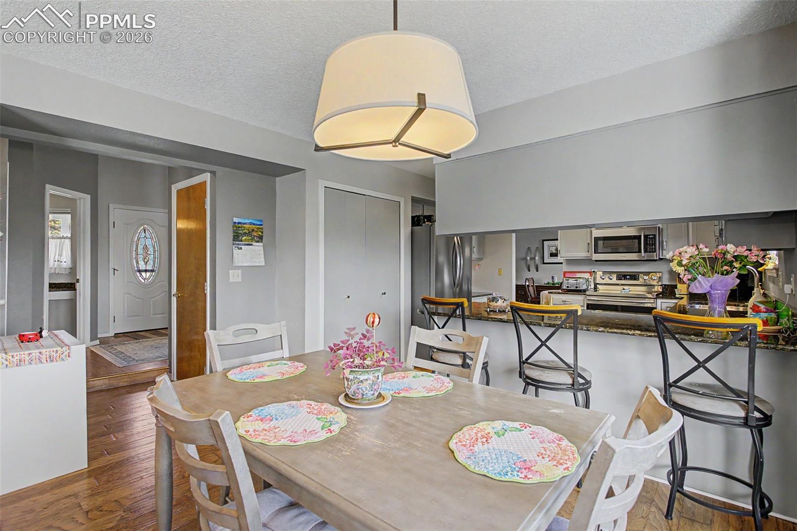 Eat-in breakfast nook- archway/hallway leads back around to the front door/door to basement/upper stairs.