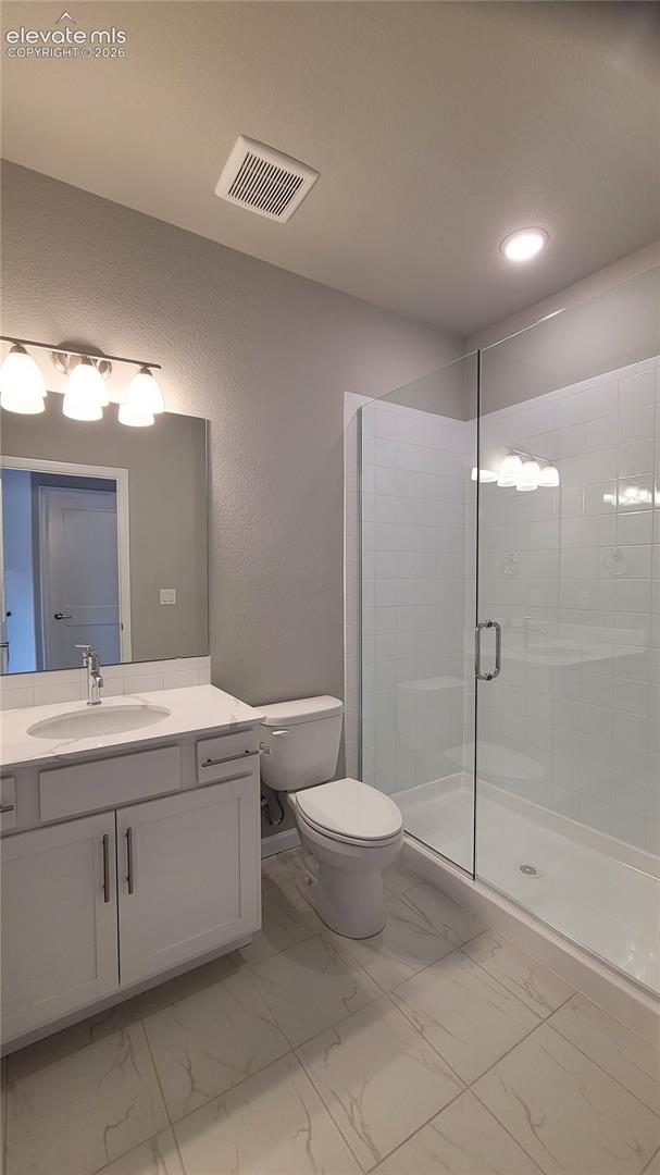 3/4 Bathroom with quartz countertop and tile surrounds, located in the basement!