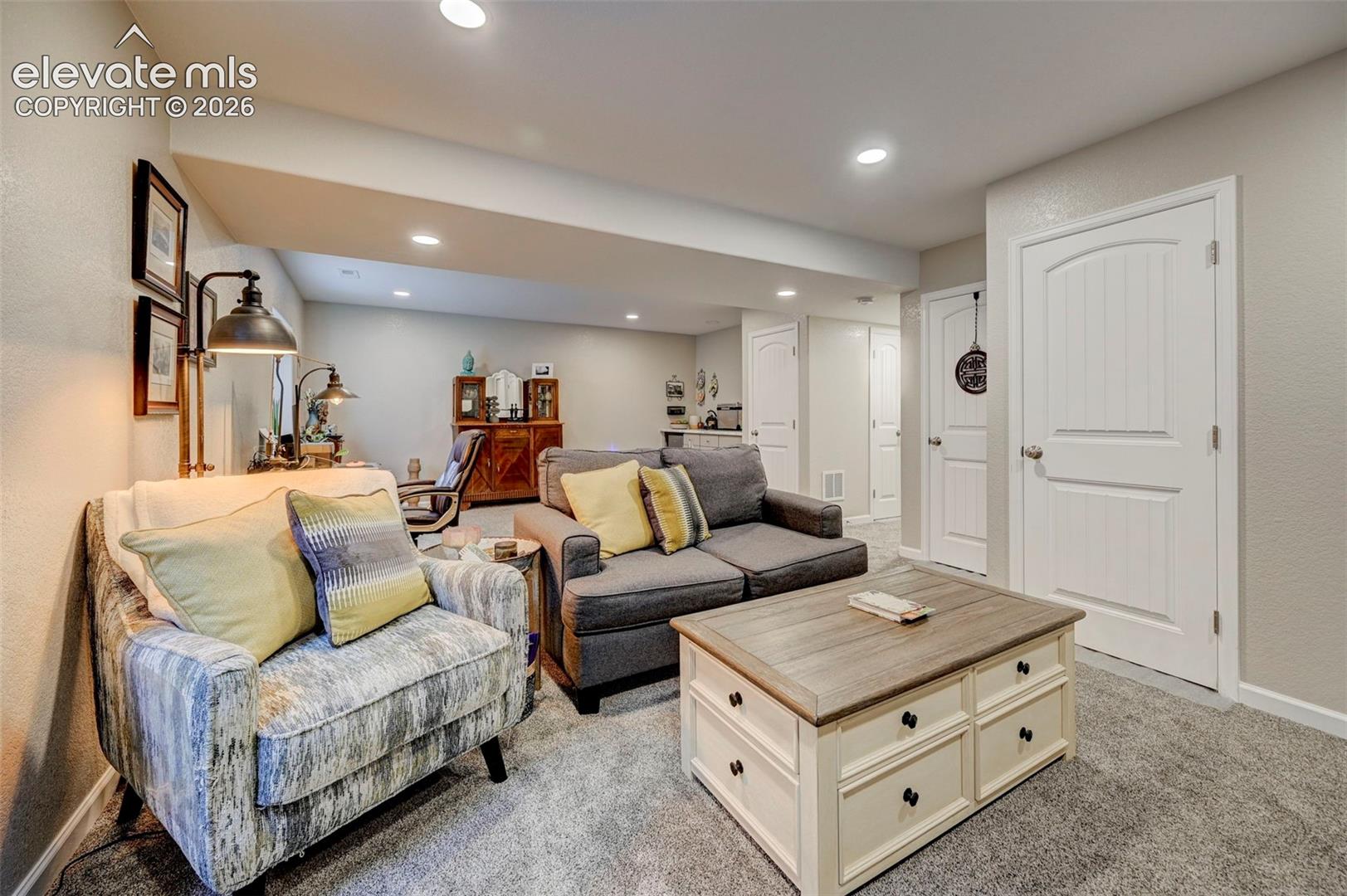 Interior space featuring neutral wall paint, recessed lighting, wall-to-wall carpeting, and white paneled doors