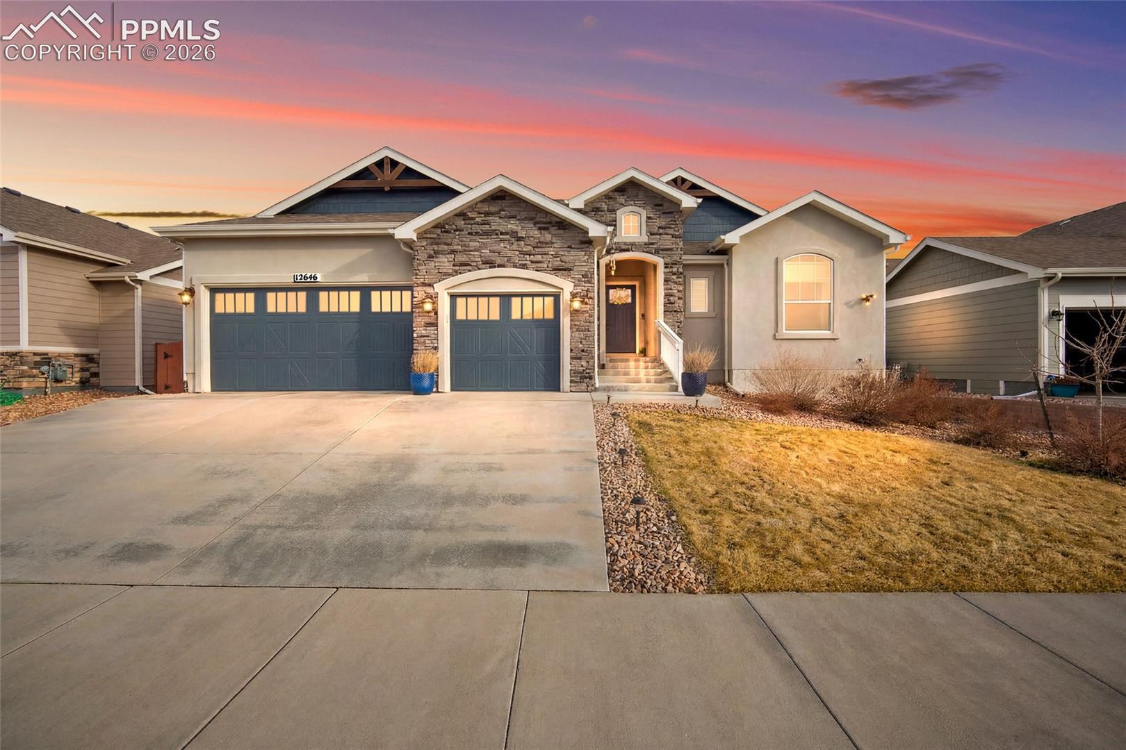 Tucked against open space with private gate access to the community trail system, this exceptional home offers thoughtful design, generous scale, and effortless livability in one of Meridian Ranch's most sought-after settings.The great room and kitchen feature 12-foot ceilings and large windows that frame open space views and fill the main level with natural light, all flowing together around a stone gas fireplace. The kitchen is outfitted with quartz countertops, a large island with bar seating, stainless appliances, a gas range, dual ovens, walk-in pantry, soft-close cabinetry, and island-integrated outlets.Four bedrooms on the main level include a primary suite with tray ceiling, dimmable lighting, jetted soaking tub, tiled shower with built-in seating, and a custom walk-in closet. A laundry room with sink and cabinetry and a pass-through mudroom add everyday functionality.The finished basement offers a recreation area with built-in surround sound, a wet bar with quartz countertops and generous seating, two bedrooms, a full bath, new LVP flooring, and ample storage. One bedroom's oversized walk-in closet makes it a natural second primary suite.Outdoor spaces include covered and open patios, recently installed turf, updated landscaping, a Colorado wildflower rock feature, and full fencing, a private, low-maintenance retreat connected to the outdoors.Additional highlights: 8,400-watt solar array, three-car garage, dual water heaters, radon mitigation, new furnace with humidifier (2023), whole-home audio, Ring cameras, programmable dimmable lighting, and hand-troweled wall and ceiling finishes throughout.Residents enjoy full access to the Meridian Ranch Recreation Center, pools, lazy river, fitness facilities, basketball courts, and community events.