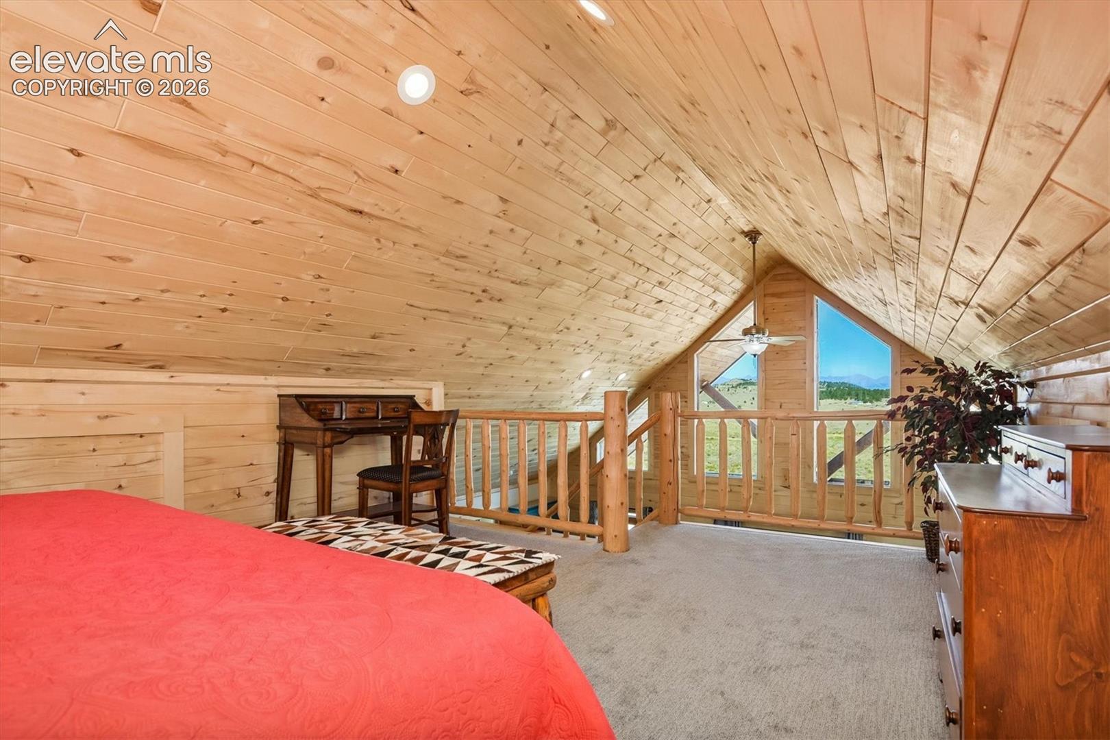 Vaulted wood-paneled ceiling with recessed lighting and a ceiling fan