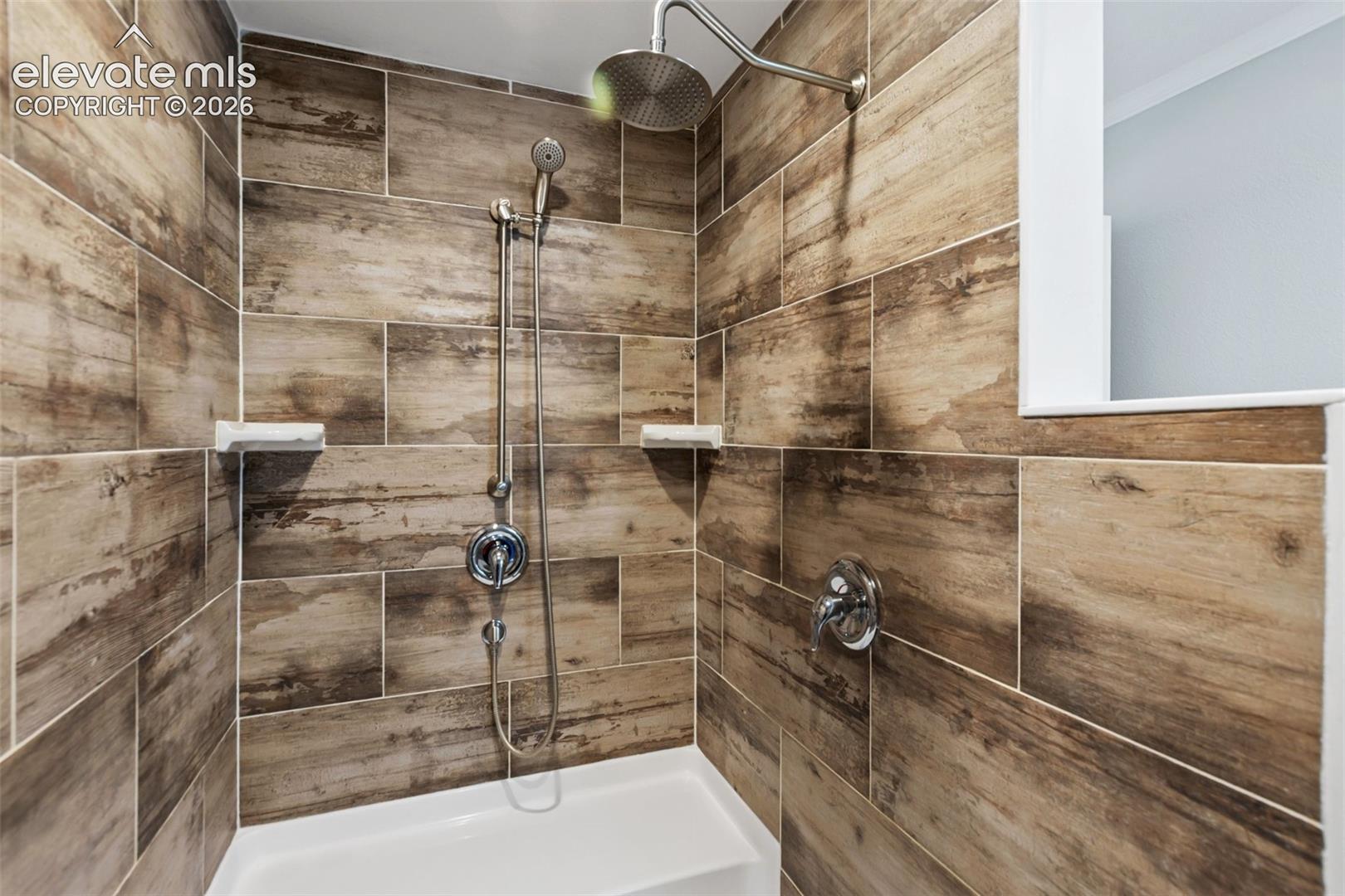 Primary Bathroom with double oversized shower.  Spa like rain shower and bench.