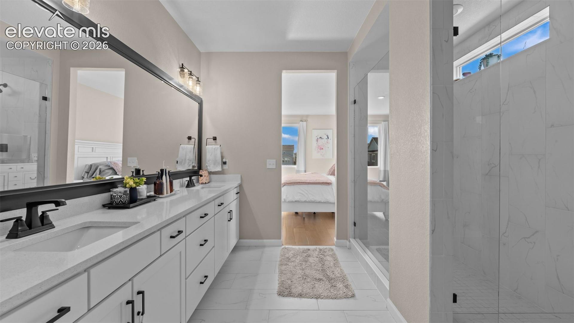 Dual vanity with undermount sinks, white cabinetry, and matte black hardware