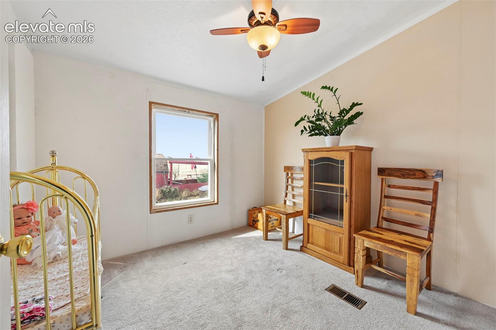 Bedroom #2 Neutral wall tones, carpeted flooring, window with natural lighting, and ceiling-mounted light fixture with fan