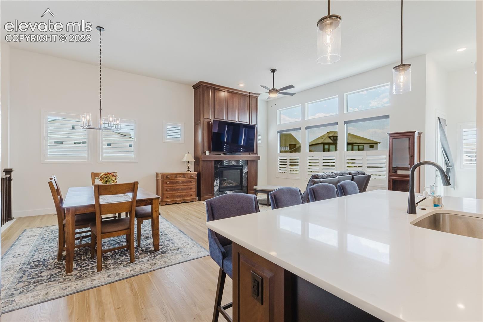 Great room with plantation shutters, custom desiged and built hardwood above the fireplace. The Great room walks out to the deck.