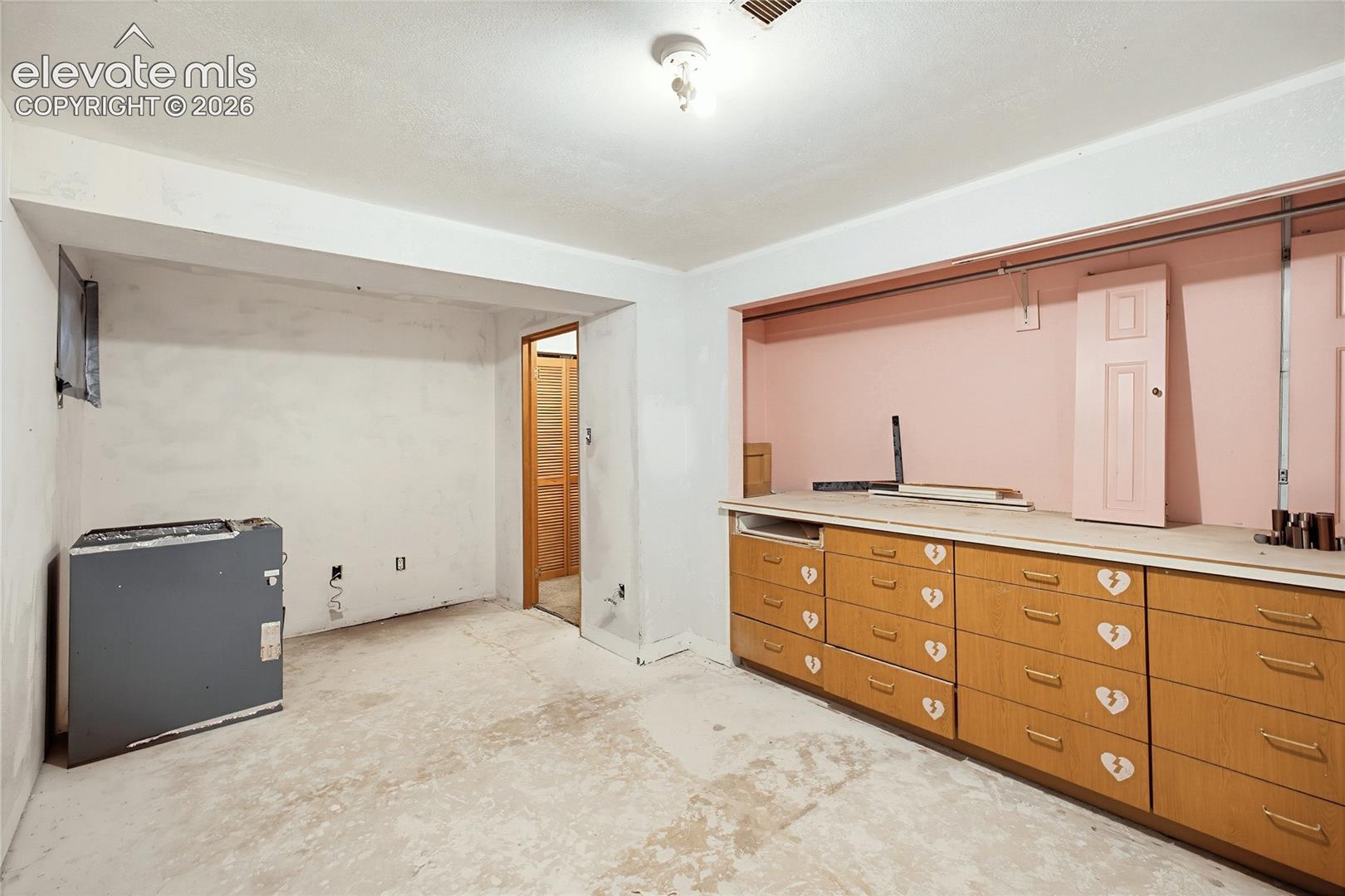 Wood-finish cabinetry with multiple drawers and a continuous countertop