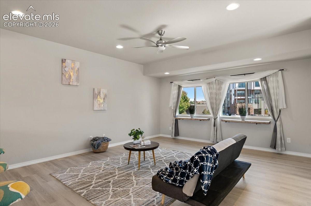 Recessed ceiling lighting, wood-finish flooring, and multiple windows with deep sills