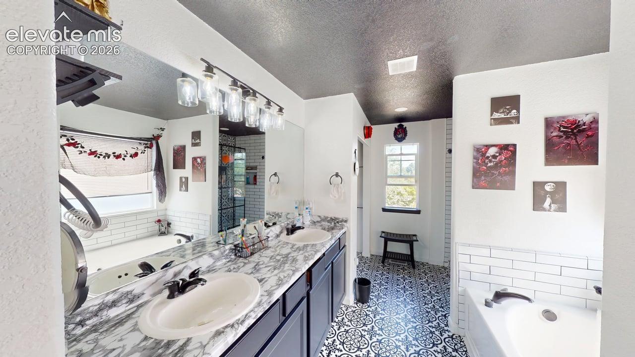 Dual vanity with oval sinks and a marble-finish countertop