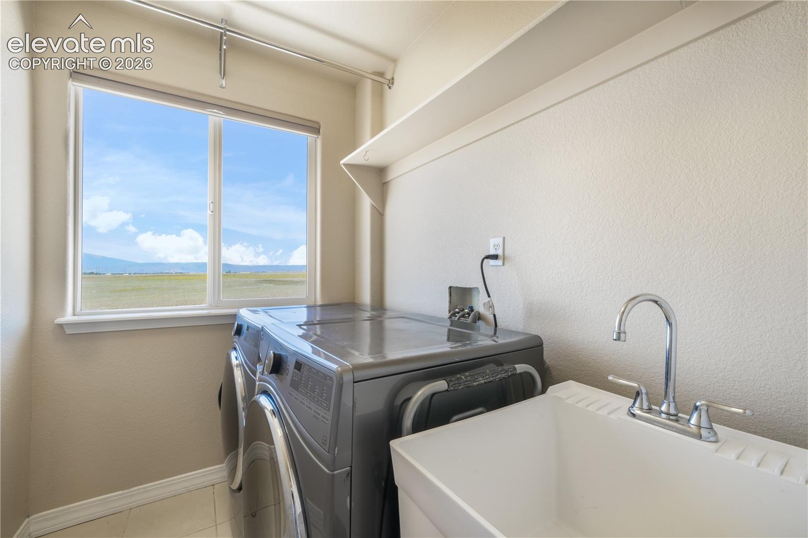 Upper Level Laundry Room with Utility Sink & Window
