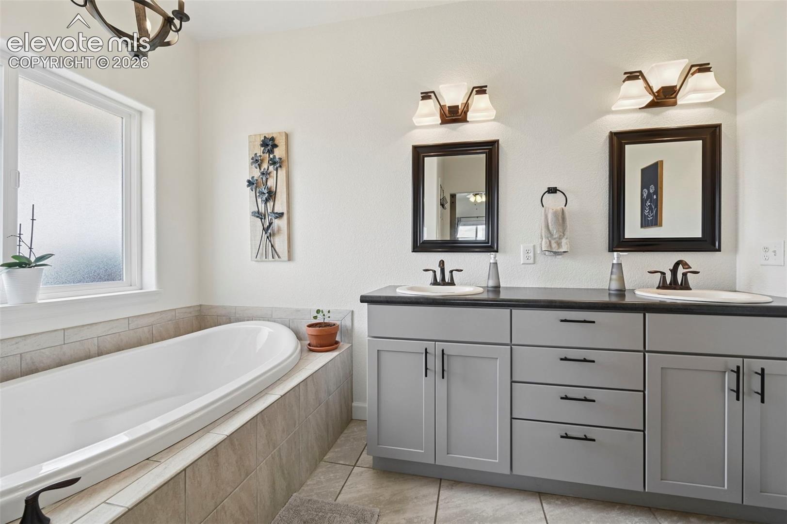 Primary Bathroom with dual vanity and tub