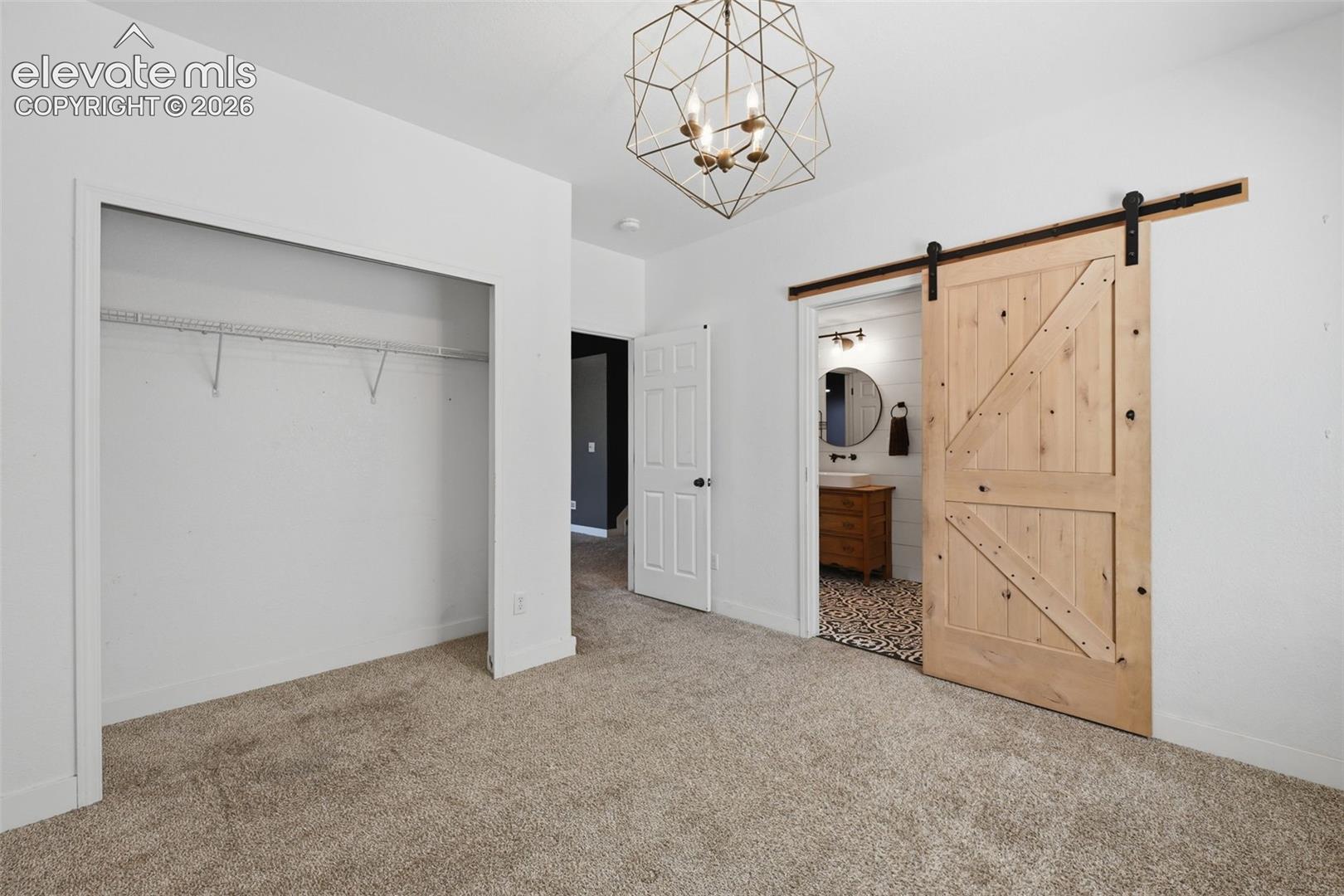 Bedroom #5 in the basement with barn door to the jack-n-jill bath!