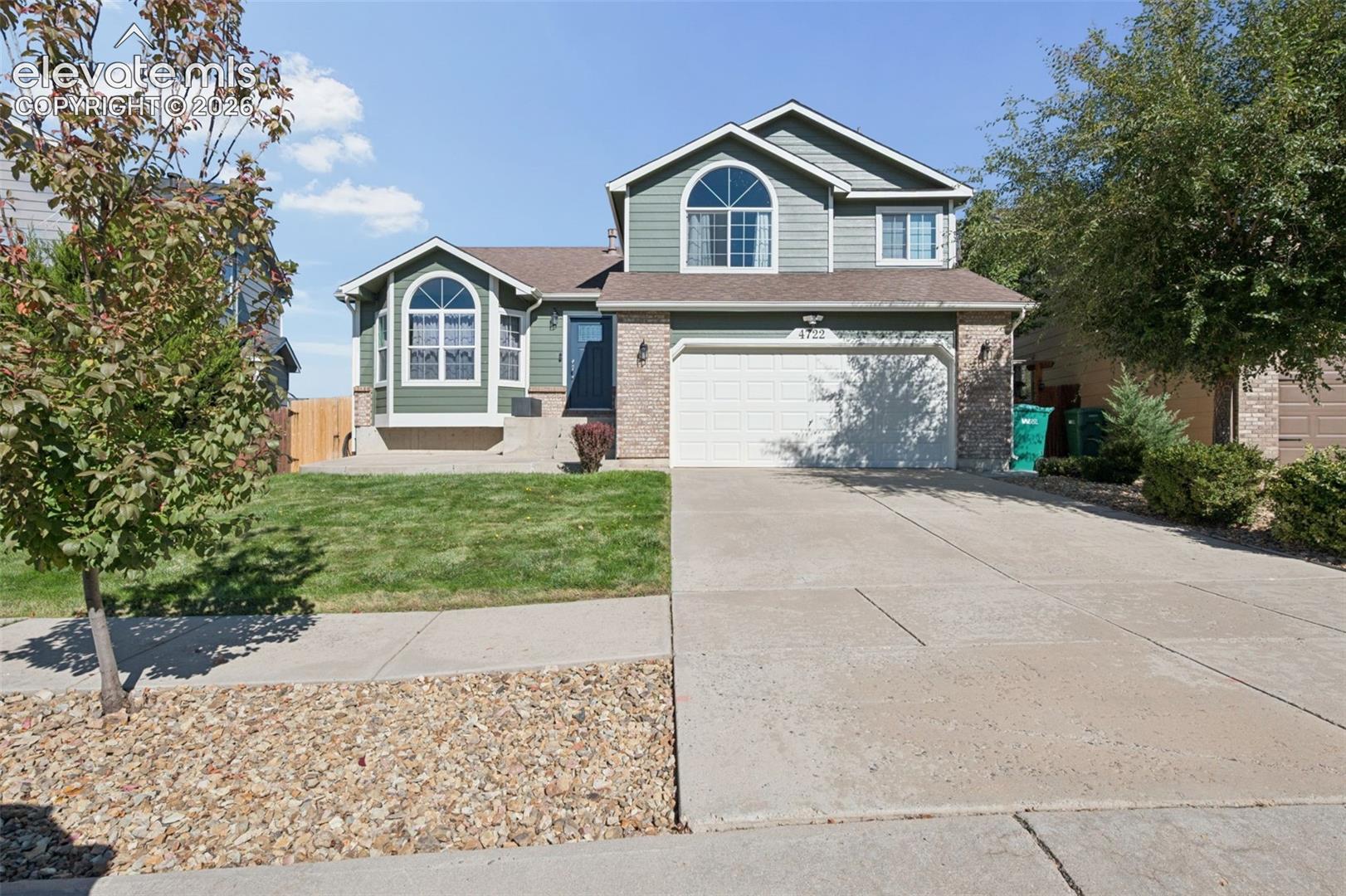 Thoughtfully updated throughout and move-in ready, this well-maintained tri-level home with a walkout basement offers vaulted ceilings, modern finishes, flexible living spaces, and established landscaping. New light fixtures, newer interior paint, and luxury vinyl plank flooring enhance the home's refreshed feel.The main level features an open, airy layout with high vaulted ceilings and a fully remodeled kitchen. Highlights include stainless steel appliances, a gas range with commercial-style range hood, pantry, new luxury vinyl plank flooring, and a large island with ample prep space and casual seating. The island also creates a natural gathering spot for family and guests.Upstairs, the primary bedroom features vaulted ceilings, built-in closet organization, and a remodeled ensuite bath with a freestanding soaking tub and separate walk-in shower. Remodeled bathrooms throughout the home carry the updated finishes into the additional living spaces.The lower level includes a family room with a gas fireplace, half bath, and office/flex room ideal for working from home, hobbies, or additional living space. The walkout basement adds another entertaining area complete with a wet bar, providing flexibility for gatherings and everyday use.Outside, the fenced backyard features mature trees, established landscaping, and lush green grass. A rear deck and large concrete patio provide multiple options for outdoor dining, entertaining, or relaxing. The established yard offers room to enjoy the outdoors while complementing the home's inviting interior.Additional features include air conditioning, newer exterior paint, updated lighting, newer interior paint, and extensive improvements throughout. With a remodeled kitchen, updated bathrooms, versatile spaces across multiple levels, and well-maintained outdoor areas, this home combines practical function with modern comfort.