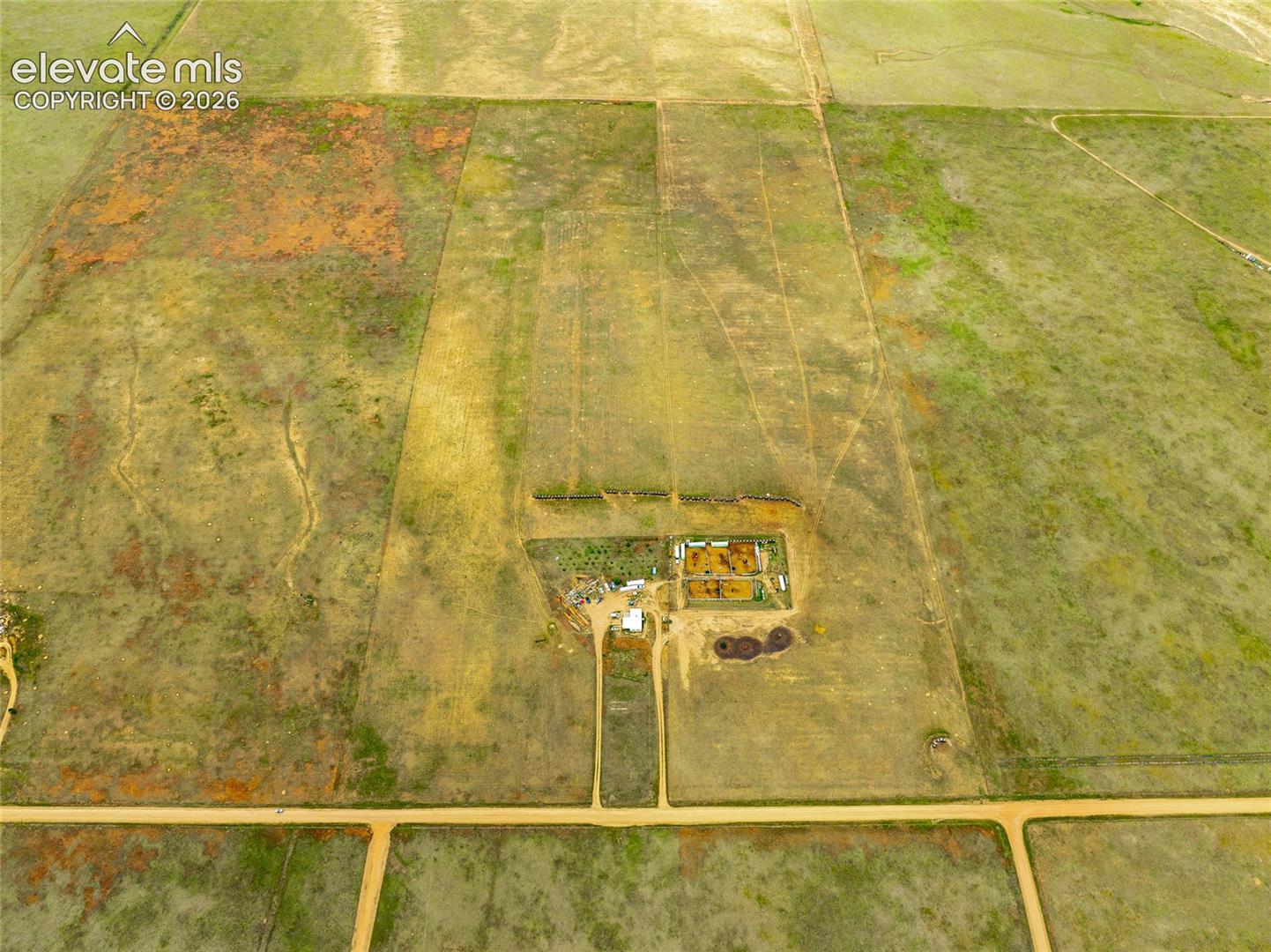 Expansive rural acreage featuring home, open pastureland, and direct dirt road access
