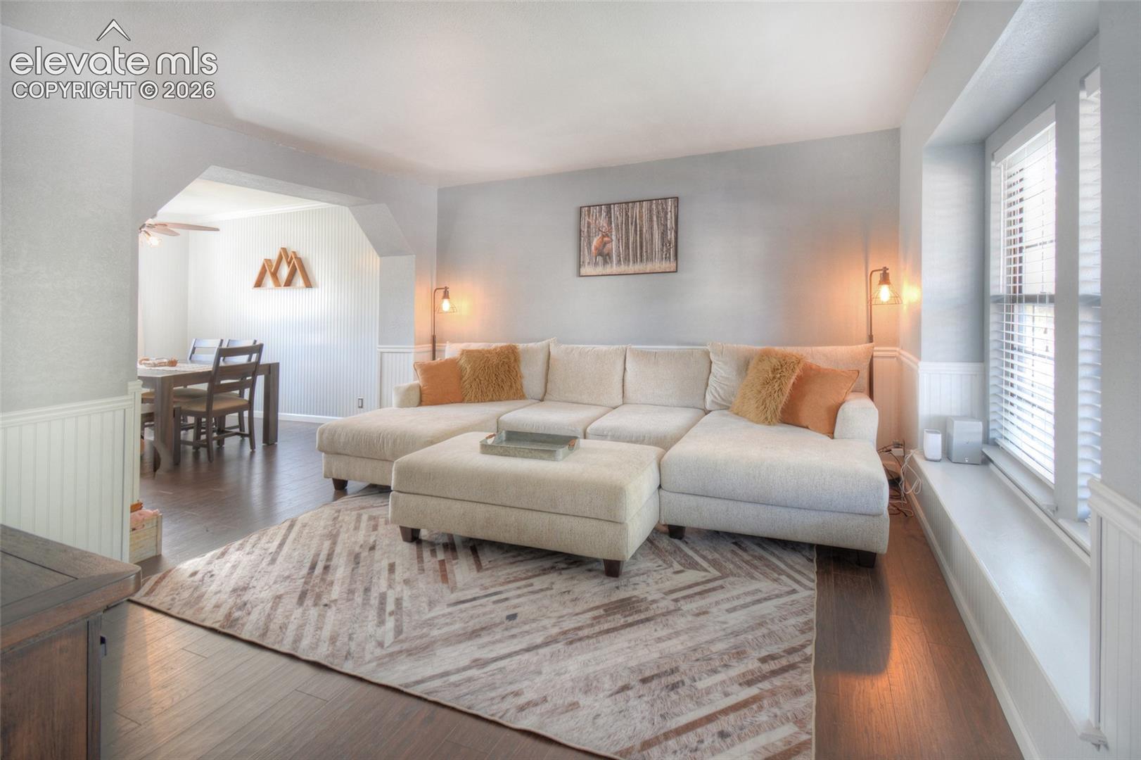 Main level living room flows to the formal dining room and features LVP flooring.
